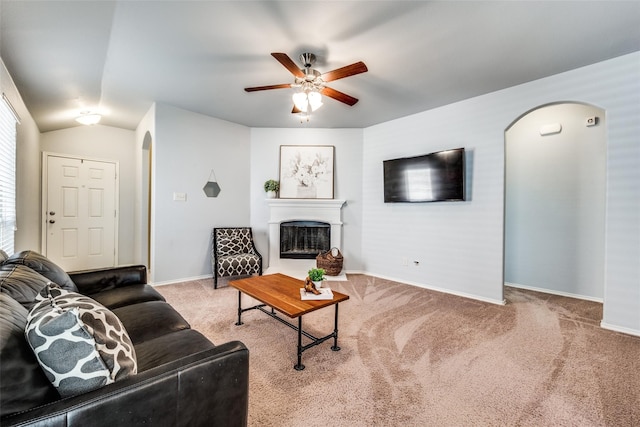 living room with carpet, ceiling fan, and vaulted ceiling