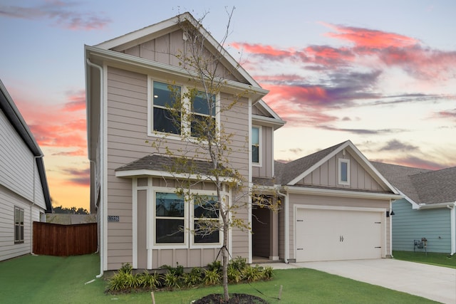 view of front of house featuring a yard and a garage