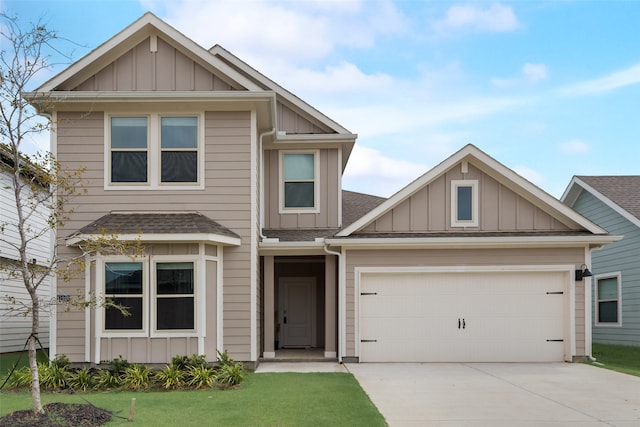 craftsman house with a front yard and a garage