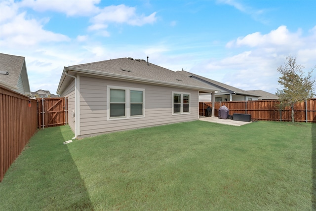 back of house featuring a lawn and a patio