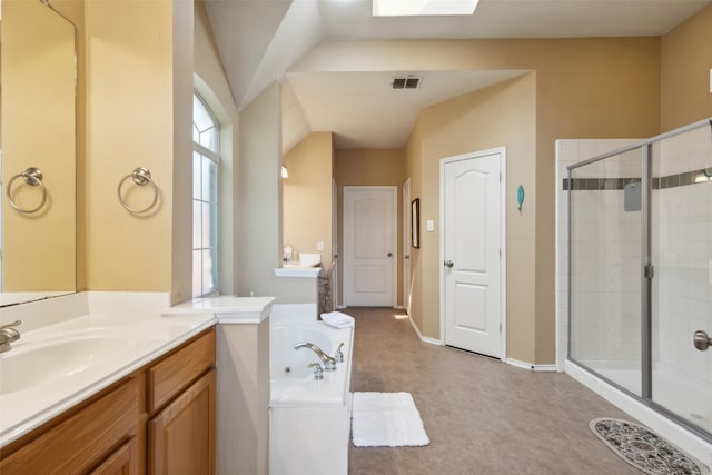 bathroom with shower with separate bathtub, vanity, and lofted ceiling with skylight