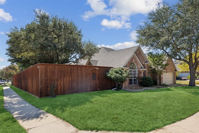 view of side of property featuring a lawn and a garage