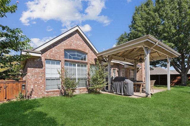 rear view of property with a patio and a lawn