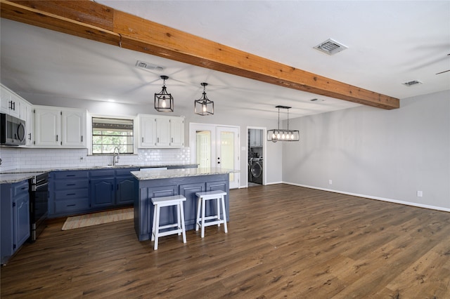 kitchen featuring white cabinets, a center island, blue cabinetry, and stainless steel appliances