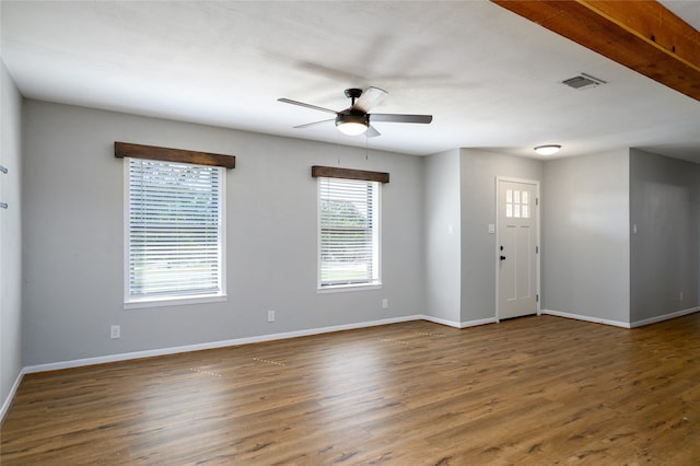 entrance foyer with beamed ceiling, dark hardwood / wood-style flooring, ceiling fan, and a wealth of natural light