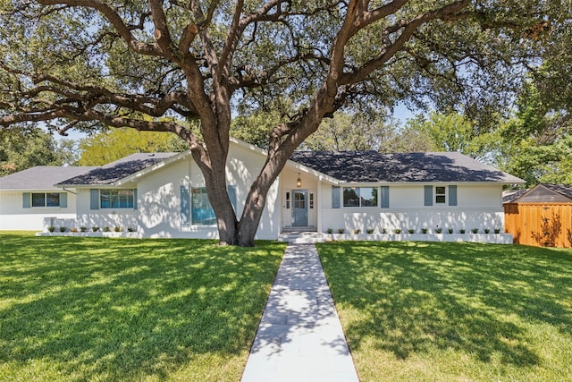 ranch-style home featuring a front yard