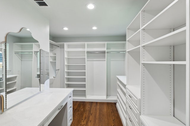 spacious closet featuring dark hardwood / wood-style flooring