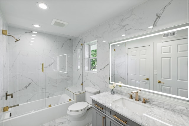 full bathroom featuring vanity, toilet, tile walls, and enclosed tub / shower combo