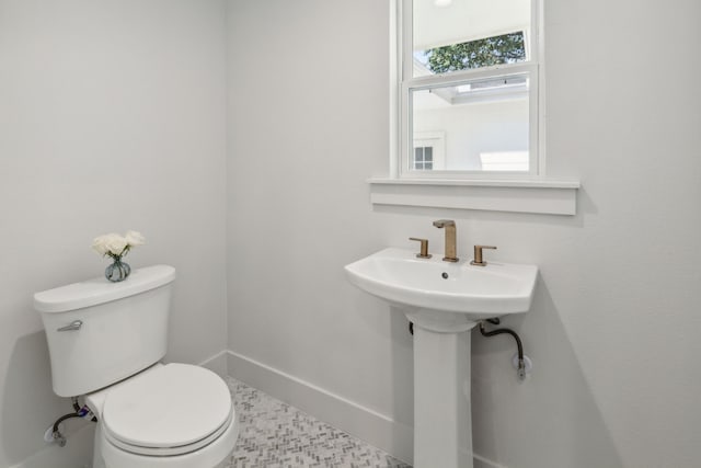 bathroom with toilet and tile patterned floors