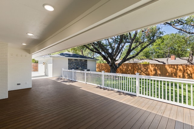 wooden deck with a lawn