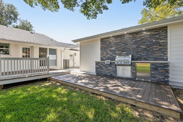 wooden terrace featuring a yard, grilling area, and area for grilling