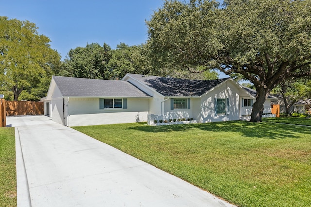 ranch-style home featuring a garage and a front yard