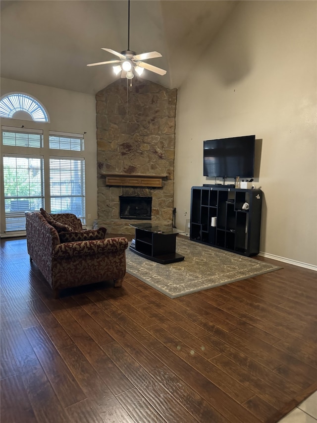 living room with high vaulted ceiling, ceiling fan, a fireplace, and dark hardwood / wood-style floors