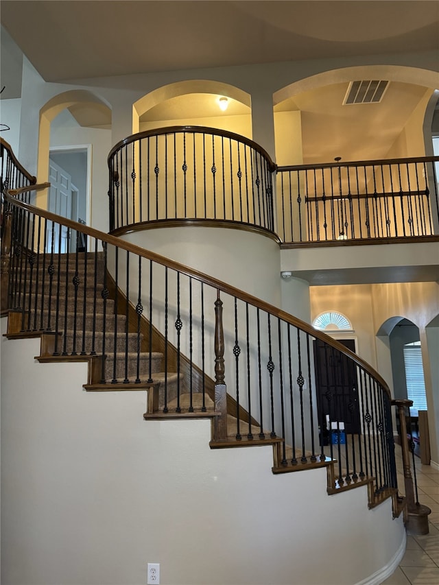 stairs featuring tile patterned flooring