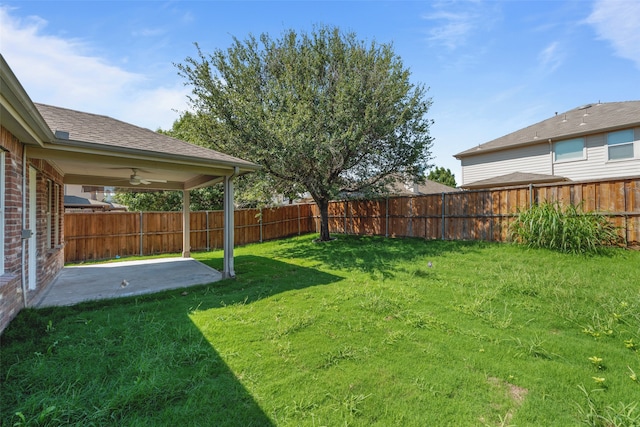 view of yard featuring ceiling fan and a patio