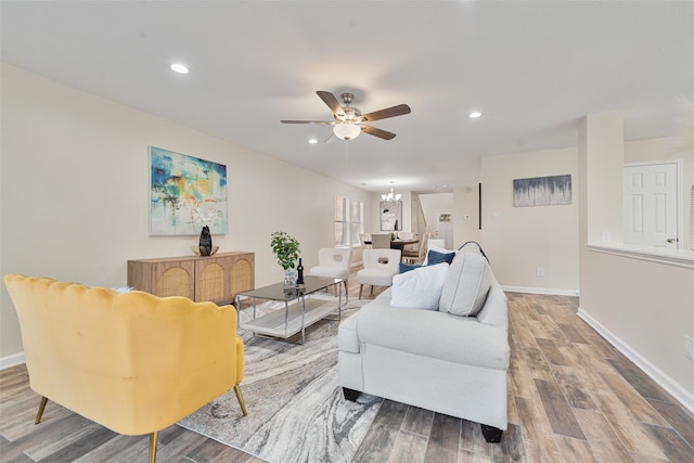 living room with ceiling fan and hardwood / wood-style floors