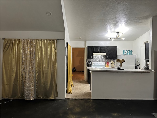 kitchen with dark carpet, white refrigerator, a textured ceiling, tasteful backsplash, and kitchen peninsula