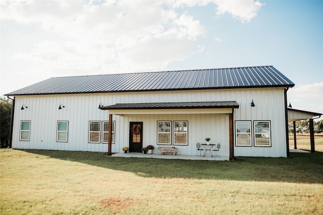 back of property featuring a yard and a patio