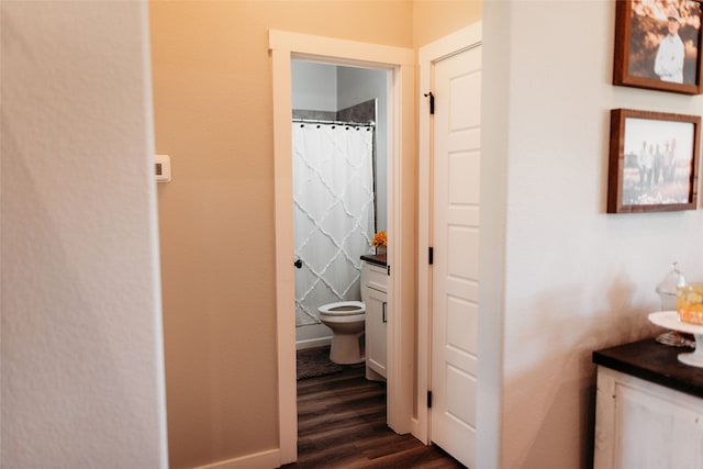 bathroom featuring hardwood / wood-style floors, vanity, and toilet