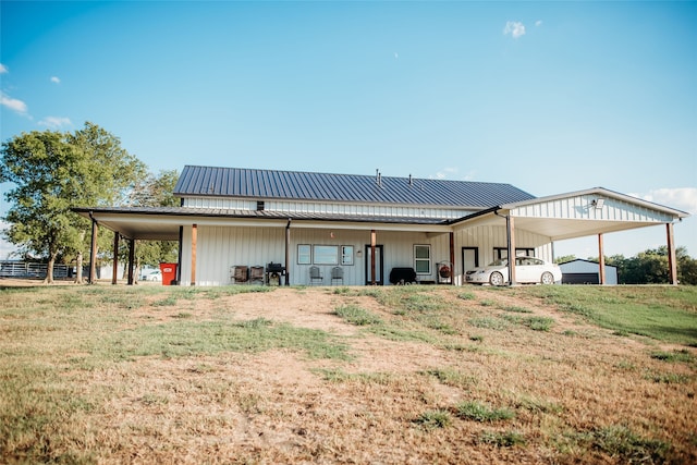 rear view of property featuring a shed and a yard