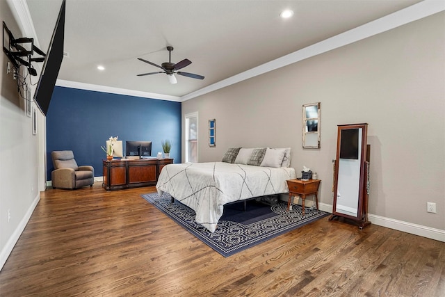 bedroom with dark hardwood / wood-style flooring, ceiling fan, and crown molding