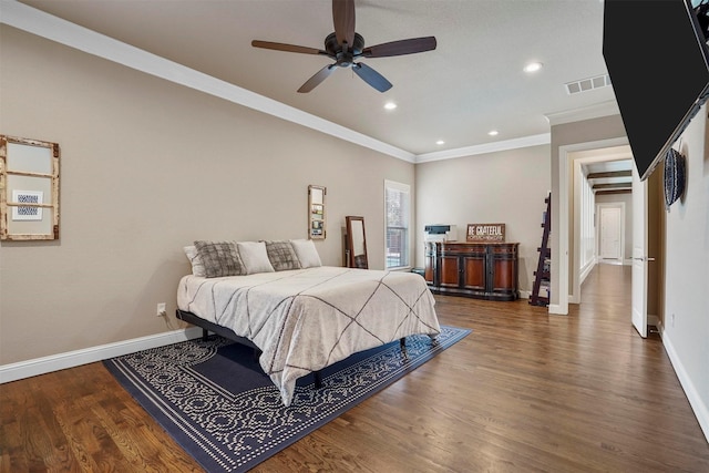 bedroom featuring dark hardwood / wood-style floors, ceiling fan, and crown molding