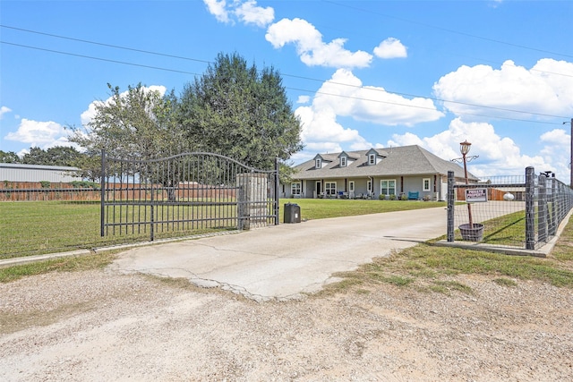 view of gate with a lawn