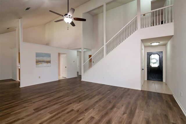 unfurnished living room with high vaulted ceiling, ceiling fan, and dark hardwood / wood-style flooring