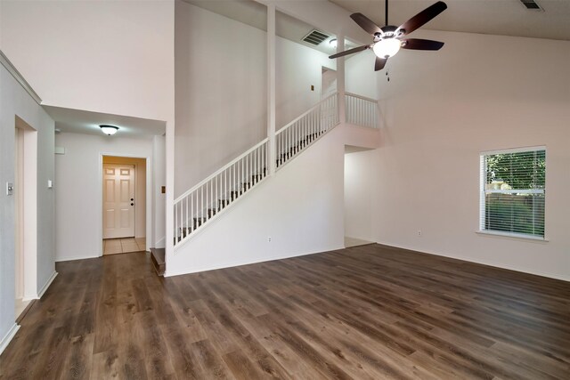 unfurnished living room with ceiling fan, dark wood-type flooring, and high vaulted ceiling