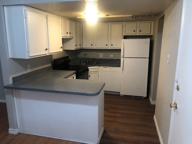 kitchen with white cabinets, backsplash, white appliances, dark hardwood / wood-style floors, and sink