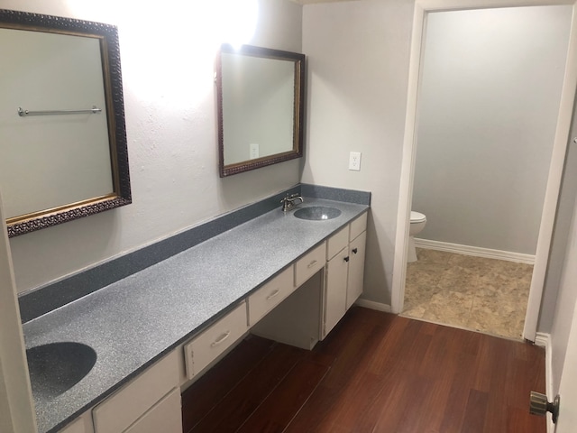 bathroom featuring vanity, toilet, and hardwood / wood-style flooring