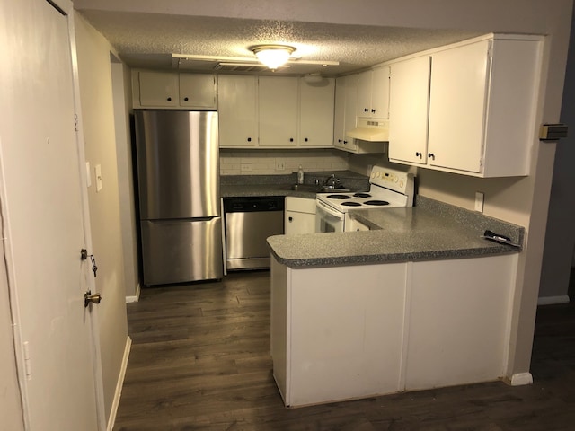 kitchen featuring decorative backsplash, stainless steel appliances, a textured ceiling, and dark hardwood / wood-style floors