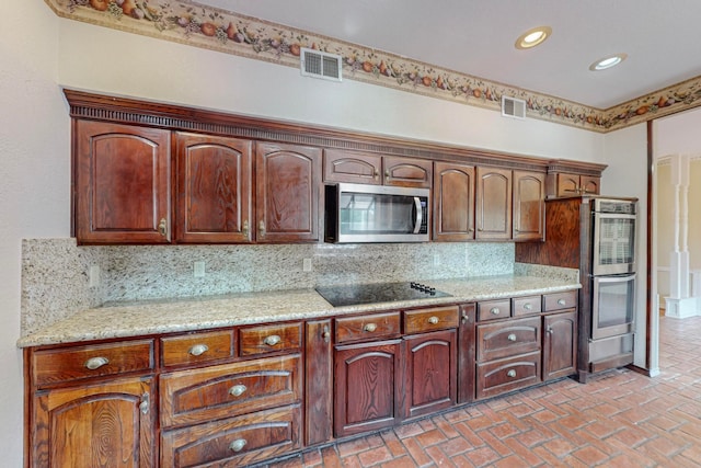 kitchen with decorative backsplash, light stone countertops, and stainless steel appliances