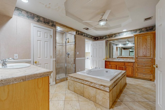 bathroom featuring ceiling fan, vanity, a raised ceiling, shower with separate bathtub, and tile patterned flooring