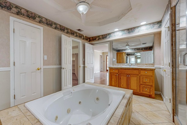 bathroom with tile patterned flooring, a raised ceiling, separate shower and tub, ceiling fan, and vanity