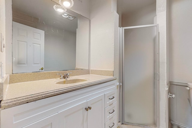 bathroom with vanity and a shower with door