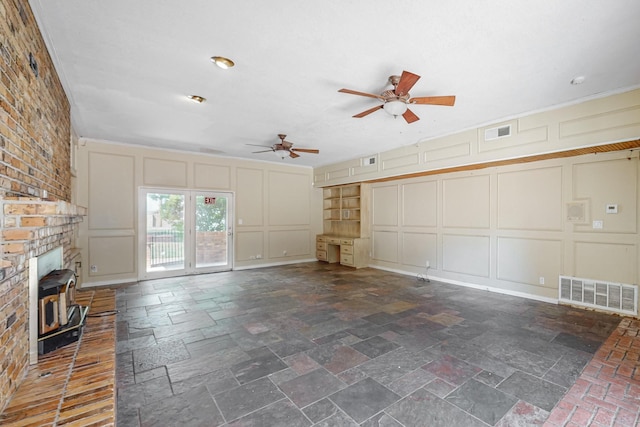 interior space featuring a brick fireplace and ceiling fan