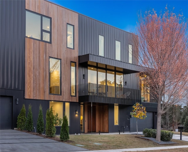 contemporary house featuring a balcony and a garage