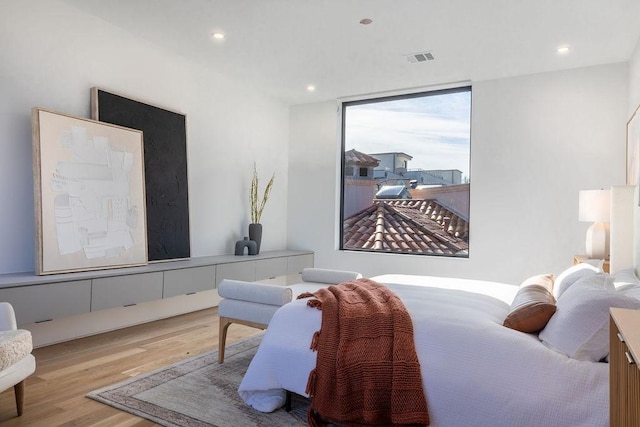 bedroom featuring light hardwood / wood-style floors and floor to ceiling windows