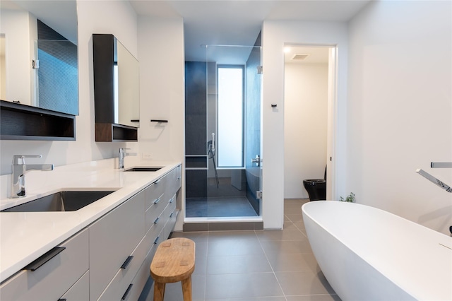 bathroom with independent shower and bath, tile patterned floors, and vanity