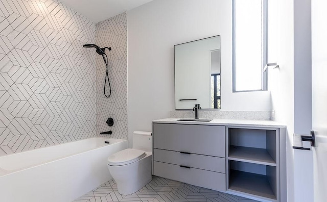 full bathroom featuring tiled shower / bath combo, toilet, and vanity