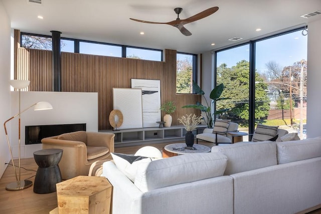 living room with hardwood / wood-style flooring, plenty of natural light, and ceiling fan