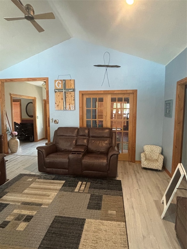 living room featuring wood-type flooring, lofted ceiling, and ceiling fan