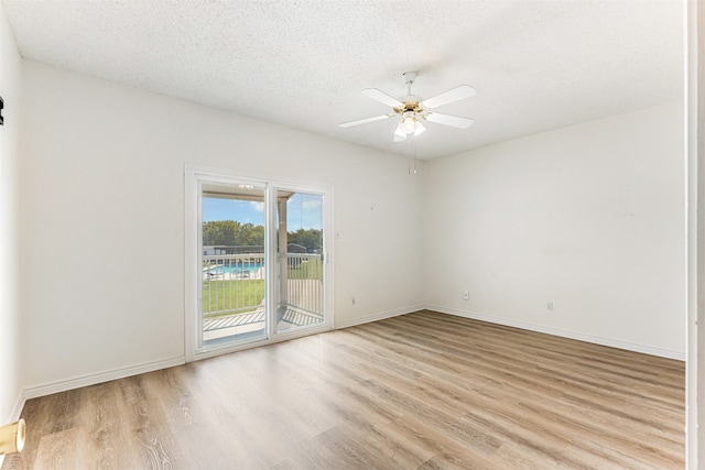 unfurnished room featuring ceiling fan, light hardwood / wood-style floors, and a textured ceiling