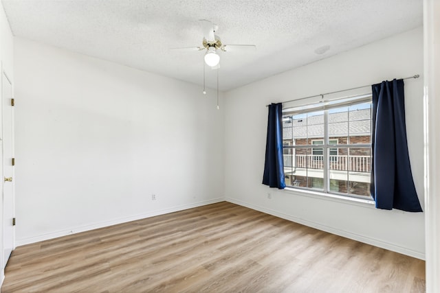 empty room featuring ceiling fan, a textured ceiling, and light hardwood / wood-style floors