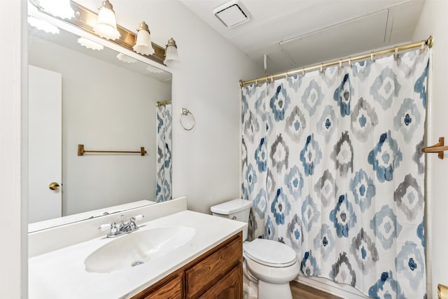 bathroom with vanity, walk in shower, and toilet