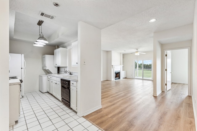 kitchen with white cabinetry, black dishwasher, sink, white refrigerator, and light hardwood / wood-style flooring