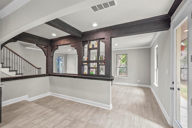 interior space with beam ceiling and crown molding