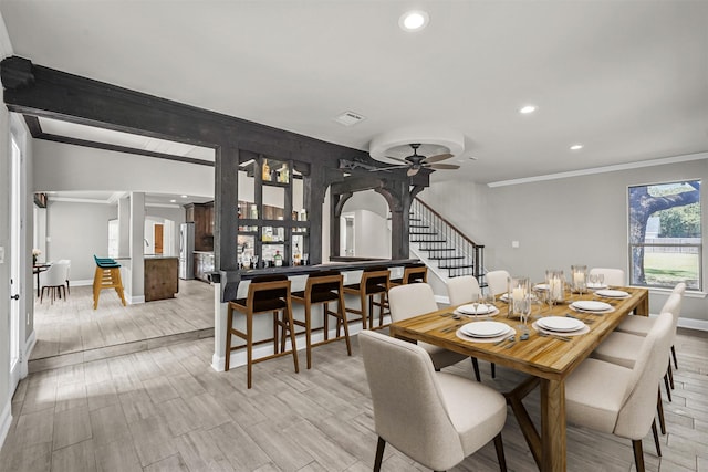 dining room with vaulted ceiling, ceiling fan, and crown molding