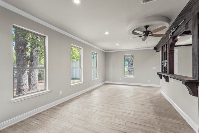 unfurnished living room featuring crown molding, ceiling fan, and a healthy amount of sunlight